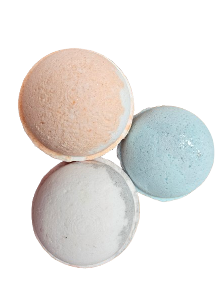 Three bath bombs in beige, gray, and light blue on a white background