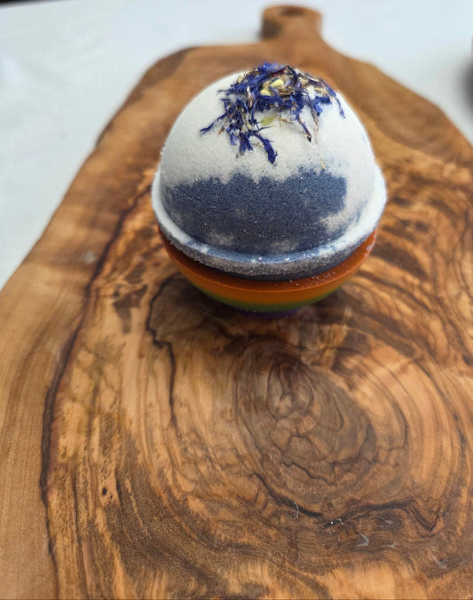 peppermint & lavender with goat milk Bath bomb with Cornflower decorative elements on a wooden cutting board