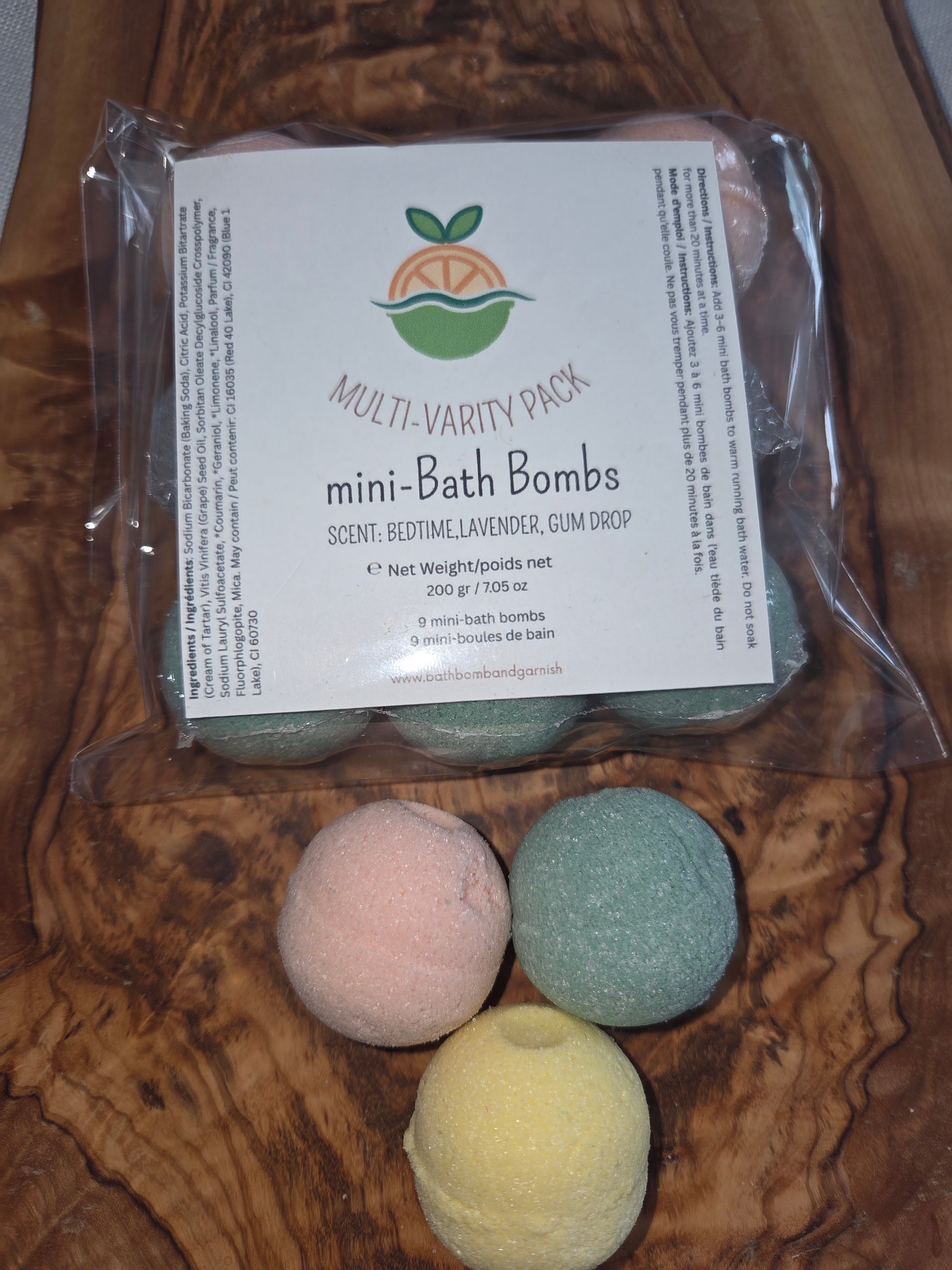 Packaged 9 mini bath bombs. Shown on a wooden surface
