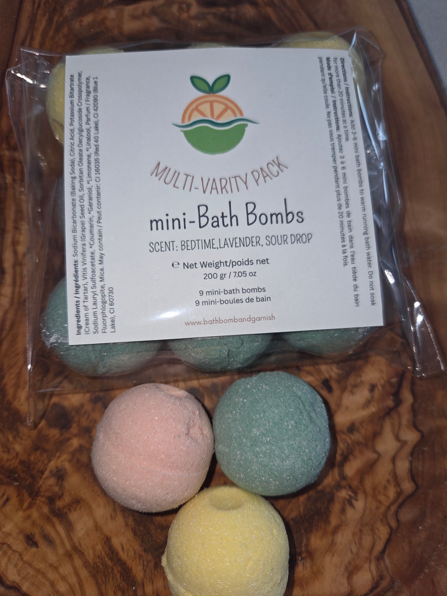 Packaged 9 mini bath bombs. Shown on a wooden surface